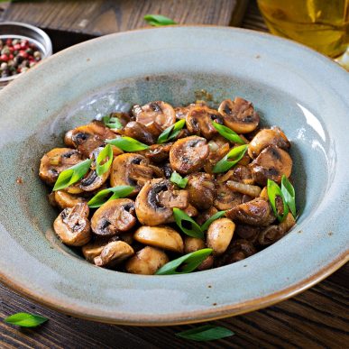 Baked mushrooms with soy sauce and herbs. Vegan food.