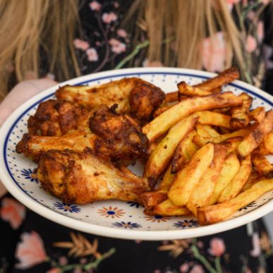 Hold a plate of hot french fries and crispy fried chicken